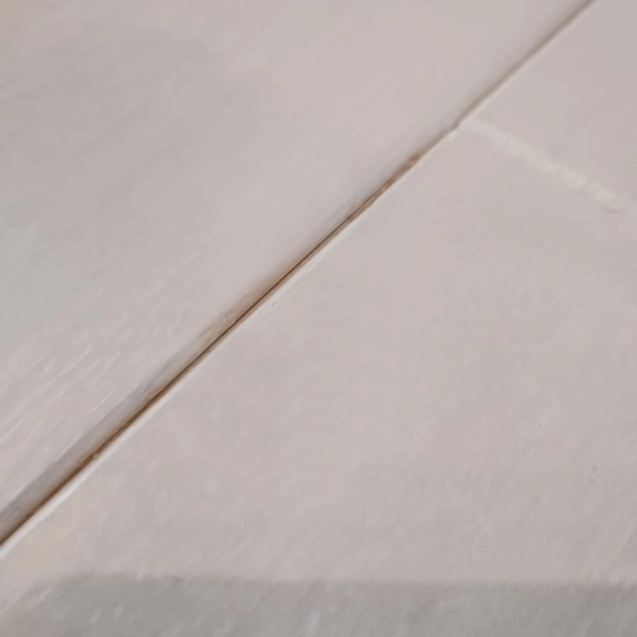 Impact mark on a varnished panel — after